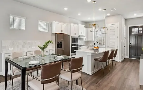 a kitchen with a table and chairs in it