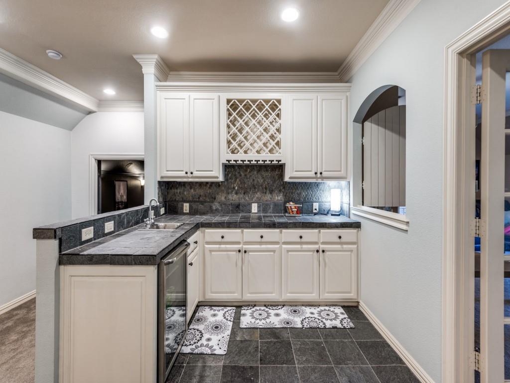 631 Deforest Court Coppell, TX 75019 - Photo 19 of 40 Upstairs kitchenette with mini refrigerator and sink. Perfect for popcorn, beverages and snacks for the game and theatre room.