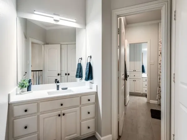 a bathroom with a sink vanity and mirror