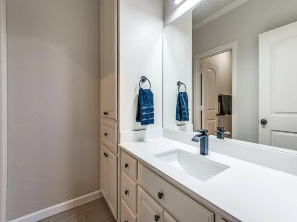 a bathroom with a double vanity sink and a mirror
