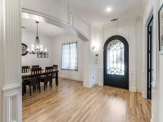 a view of a livingroom kitchen and dining room with wooden floor