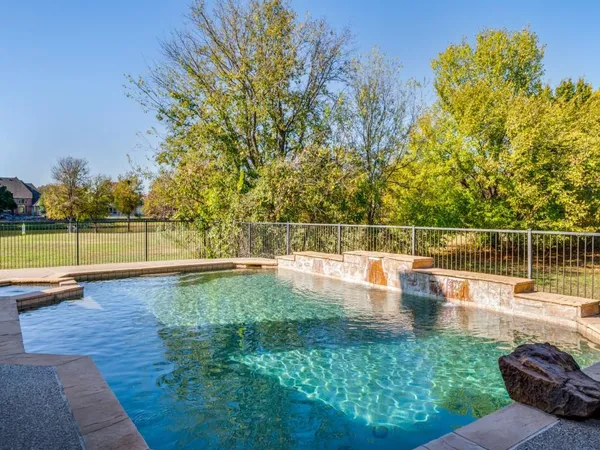 a view of a swimming pool with a patio