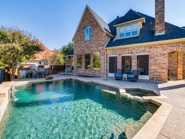 a view of a house with swimming pool patio and sitting area
