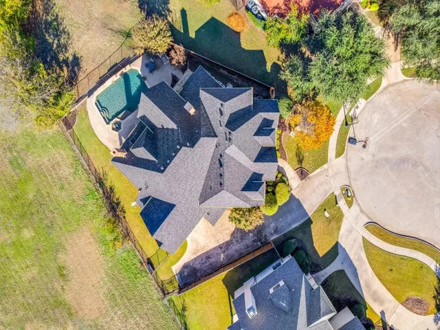 an aerial view of a house with a swimming pool