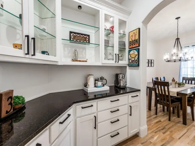 a kitchen with stainless steel appliances granite countertop a sink and a stove with wooden floor