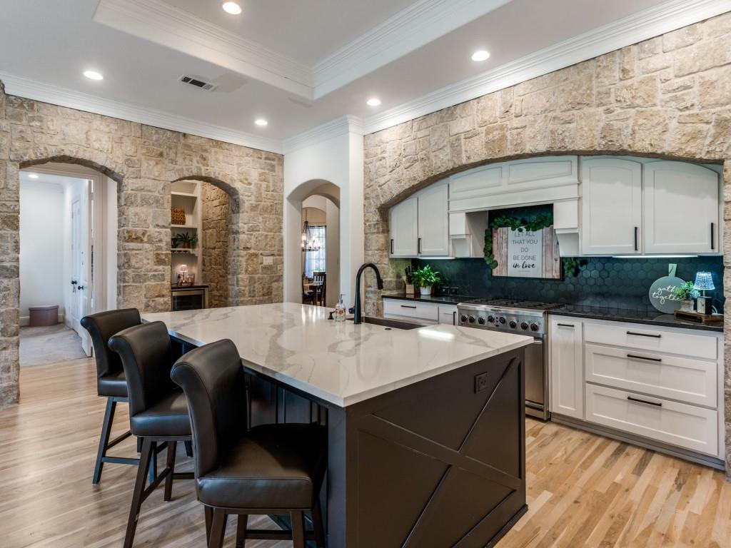 631 Deforest Court Coppell, TX 75019 - Photo 7 of 40 Updated kitchen with gorgeous quartz island, stainless gourmet appliances, under counter lighting and coffee wine bar grotto.