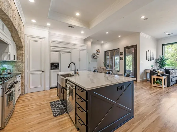 a kitchen with counter top space sink stove and refrigerator