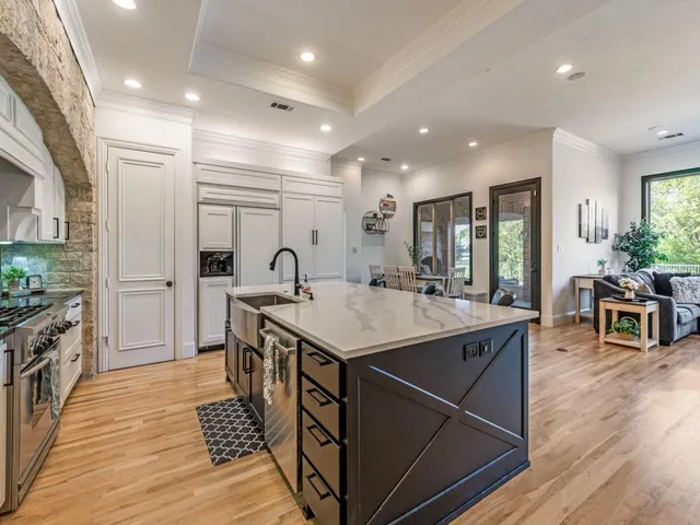 a kitchen with counter top space sink stove and refrigerator