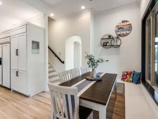 a view of a hallway with furniture and wooden floor