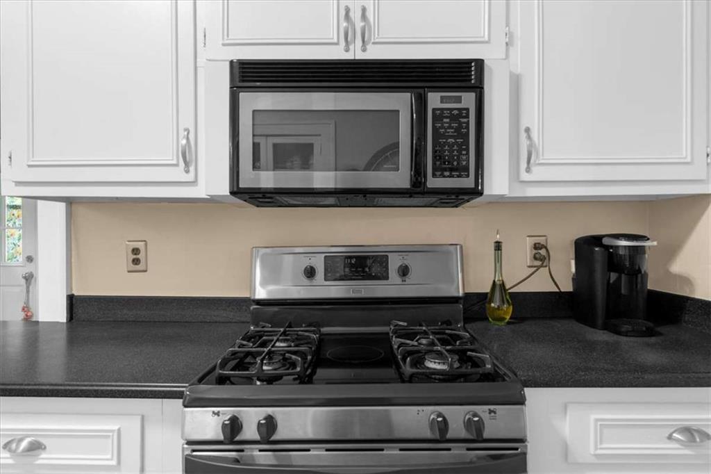 106 Westmore Road Southwest Rome, GA 30165 - Photo 14 of 56 a kitchen with granite countertop white cabinets and black appliances