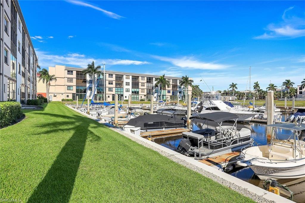 803 River Point Drive, Unit 201B Naples, FL 34102 - Photo 21 of 21 a view of a lake with couches and city view