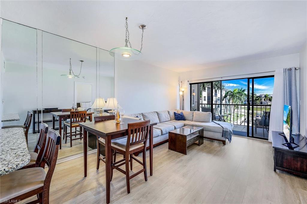 803 River Point Drive, Unit 201B Naples, FL 34102 - Photo 7 of 21 a view of a livingroom and dining room