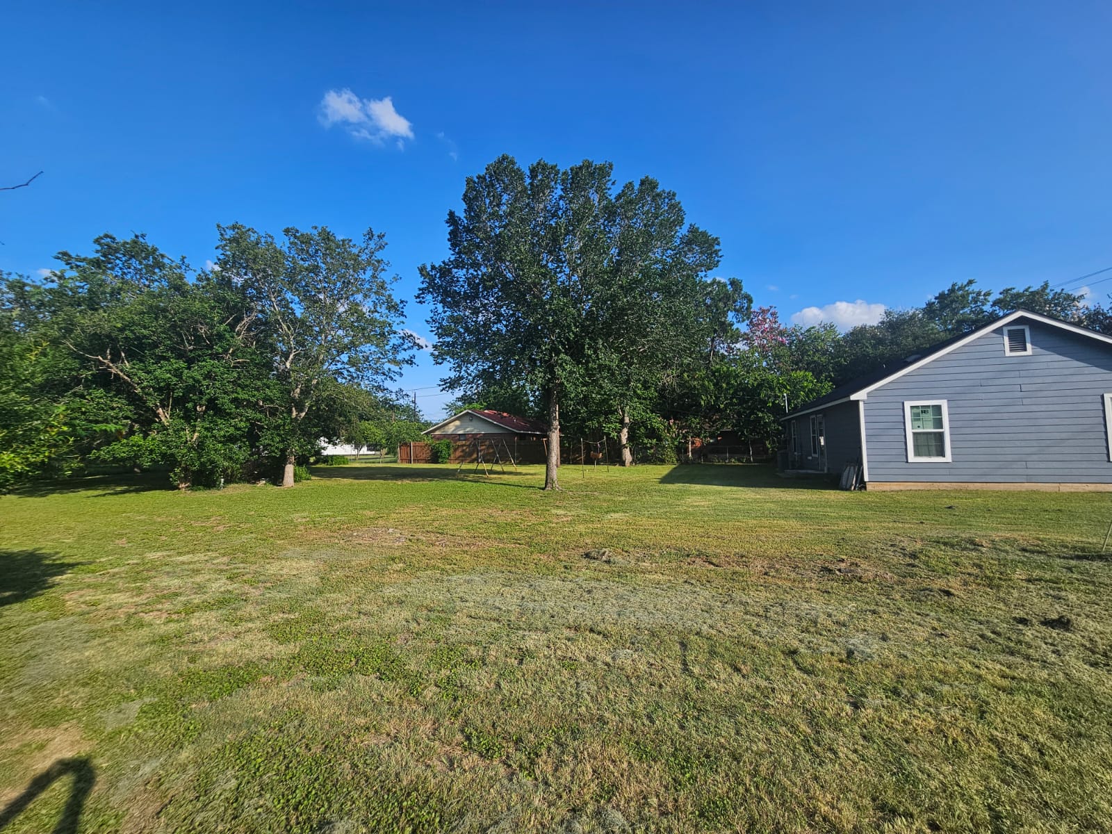 606 Trinity Street Lockhart, TX 78644 - Photo 20 of 23 A spacious backyard with mature trees provides ample room for outdoor activities.