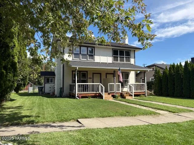 a view of a house with a yard porch and sitting area