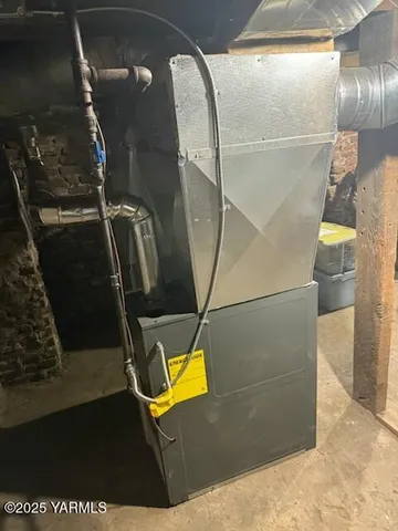 a living room with a couch and a stove next to a window