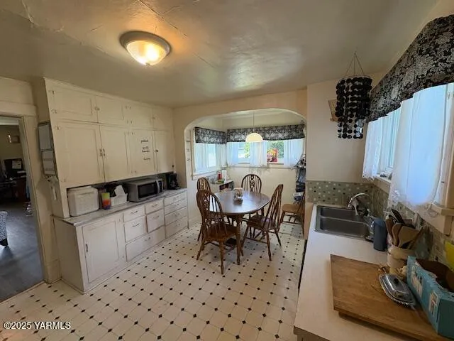 a dining room with furniture and window