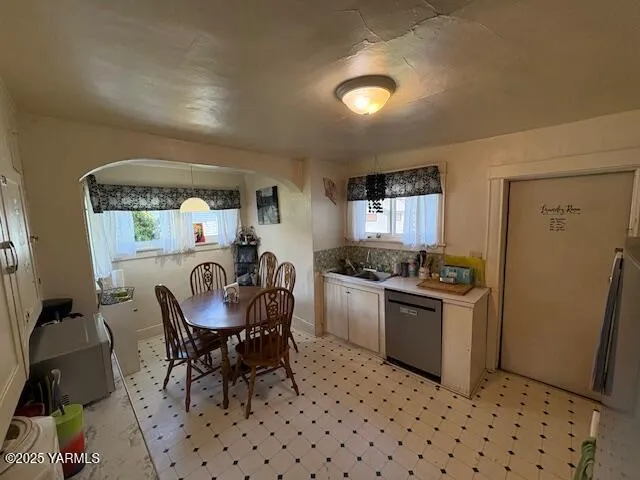 a kitchen with stainless steel appliances granite countertop a sink a stove a refrigerator a microwave oven with a dining table and chair