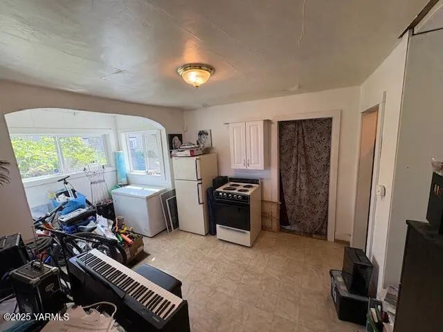 a bedroom with furniture and a large window