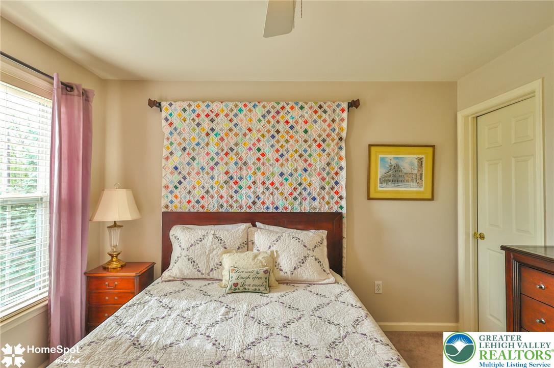 4191 Walter Road Bethlehem, PA 18020 - Photo 15 of 23 A well-lit bedroom provides a cozy retreat, featuring a classic wooden bed frame and soft, inviting textures.