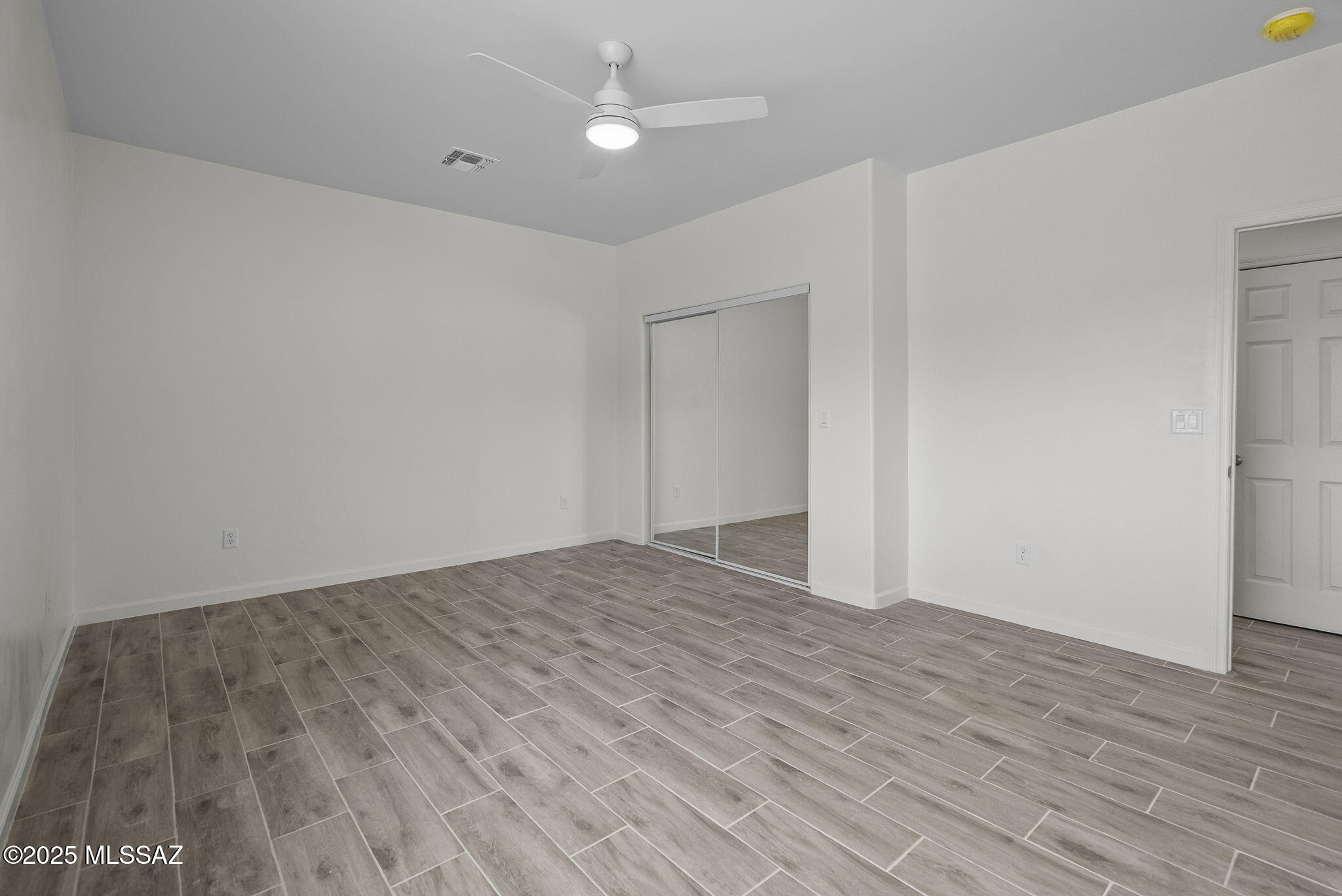 1895 Roma Court Rio Rico, AZ 85648 - Photo 18 of 42 a view of empty room with wooden floor