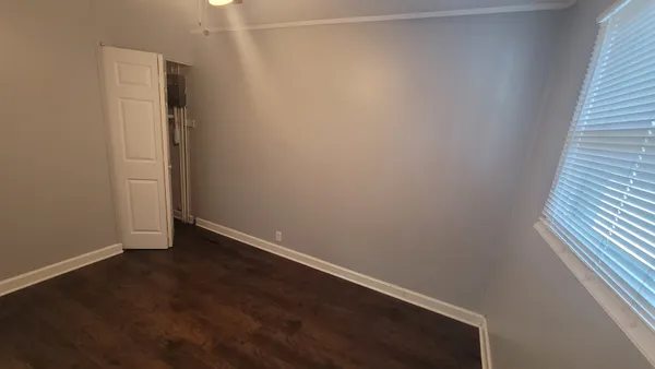 an empty room with wooden floor