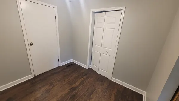 an empty room with wooden floor