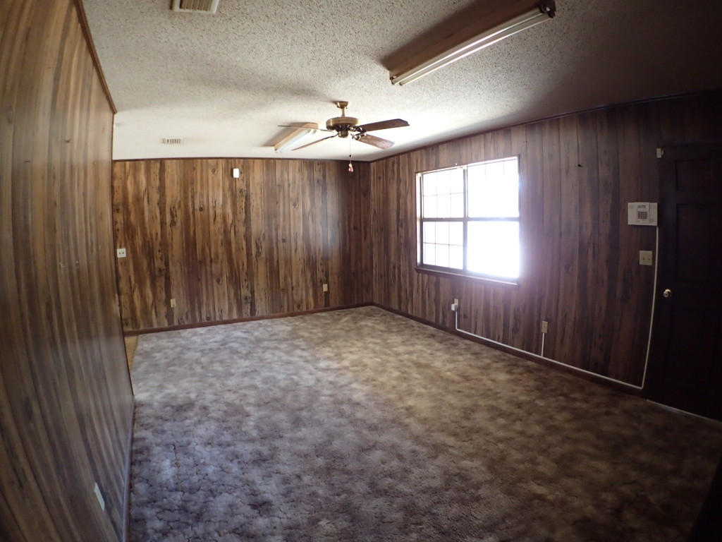 5326 Olin Merritt Street Baker, FL 32531 - Photo 2 of 9 an empty room with windows and fan