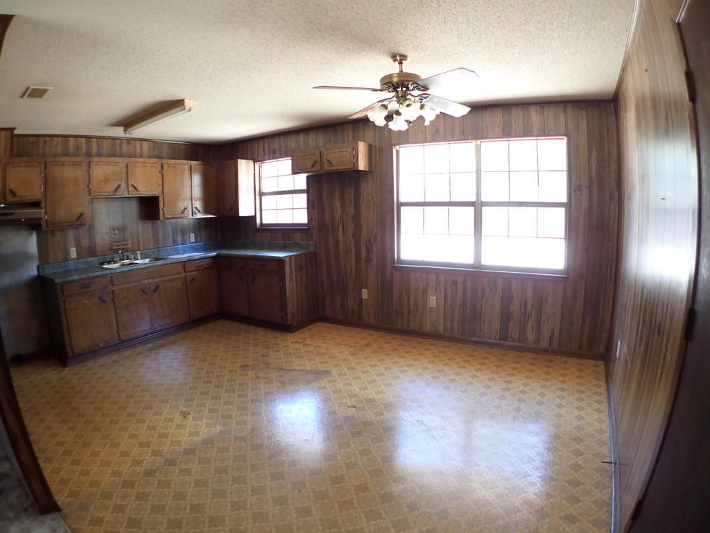 5326 Olin Merritt Street Baker, FL 32531 - Photo 3 of 9 an empty room with chandelier fan and windows