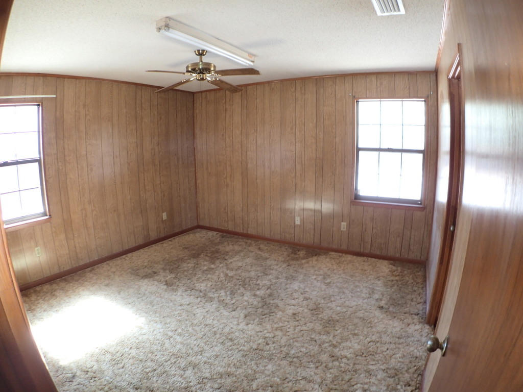 5326 Olin Merritt Street Baker, FL 32531 - Photo 5 of 9 an empty room with windows and entrance