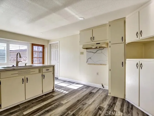 a kitchen with stainless steel appliances granite countertop a refrigerator and a stove