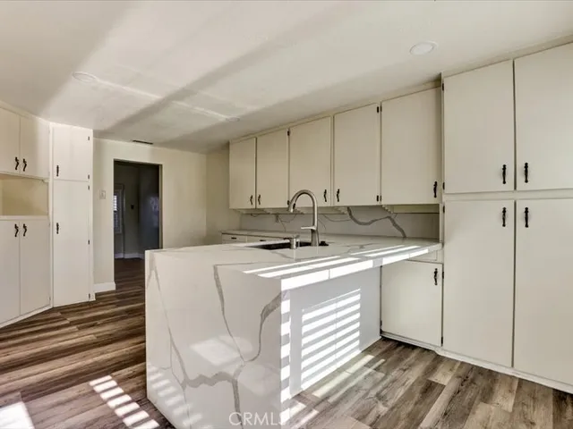 a kitchen that has a sink and a stove in it