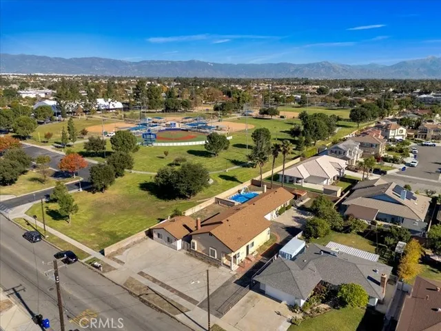 an aerial view of residential houses with outdoor space and swimming pool