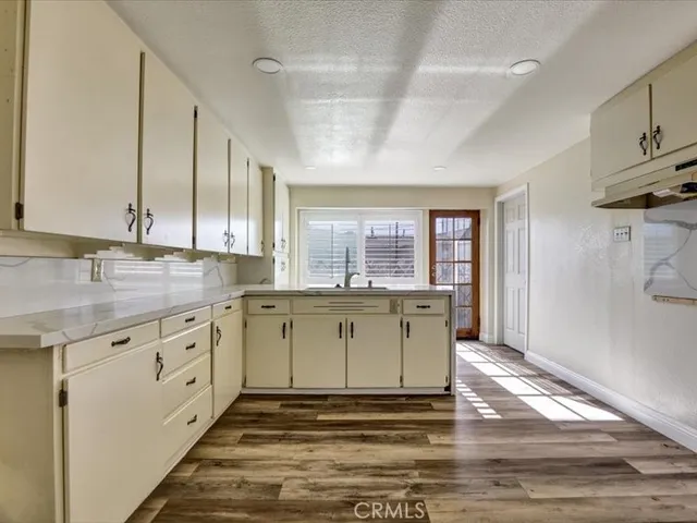 a bathroom with a granite countertop sink and a window