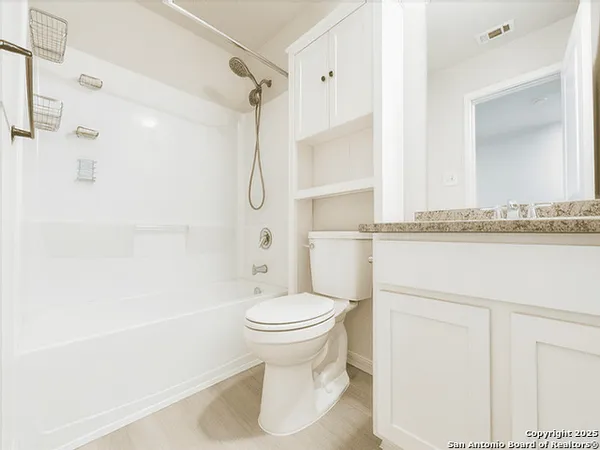 a bathroom with a toilet sink and shower