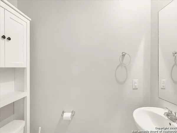a bathroom with a sink and mirror