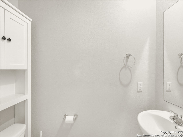 3831 Key W Way Converse, TX 78109 - Photo 13 of 18 a bathroom with a sink and mirror