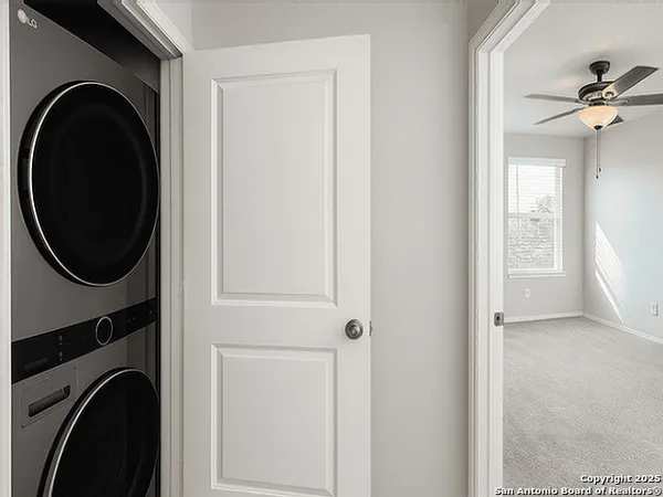 a view of a hallway with washer and dryer