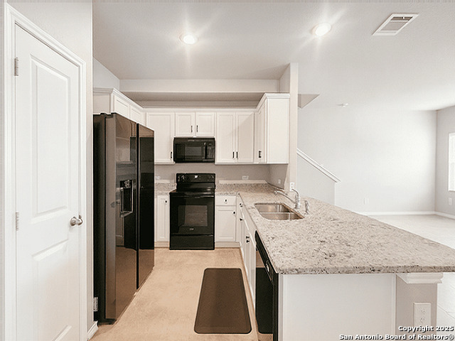 3831 Key W Way Converse, TX 78109 - Photo 2 of 18 a kitchen with stainless steel appliances granite countertop a refrigerator a stove and a sink