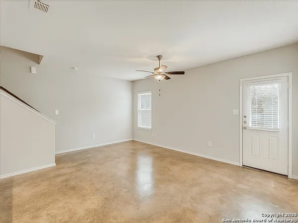 a view of an empty room with a fan