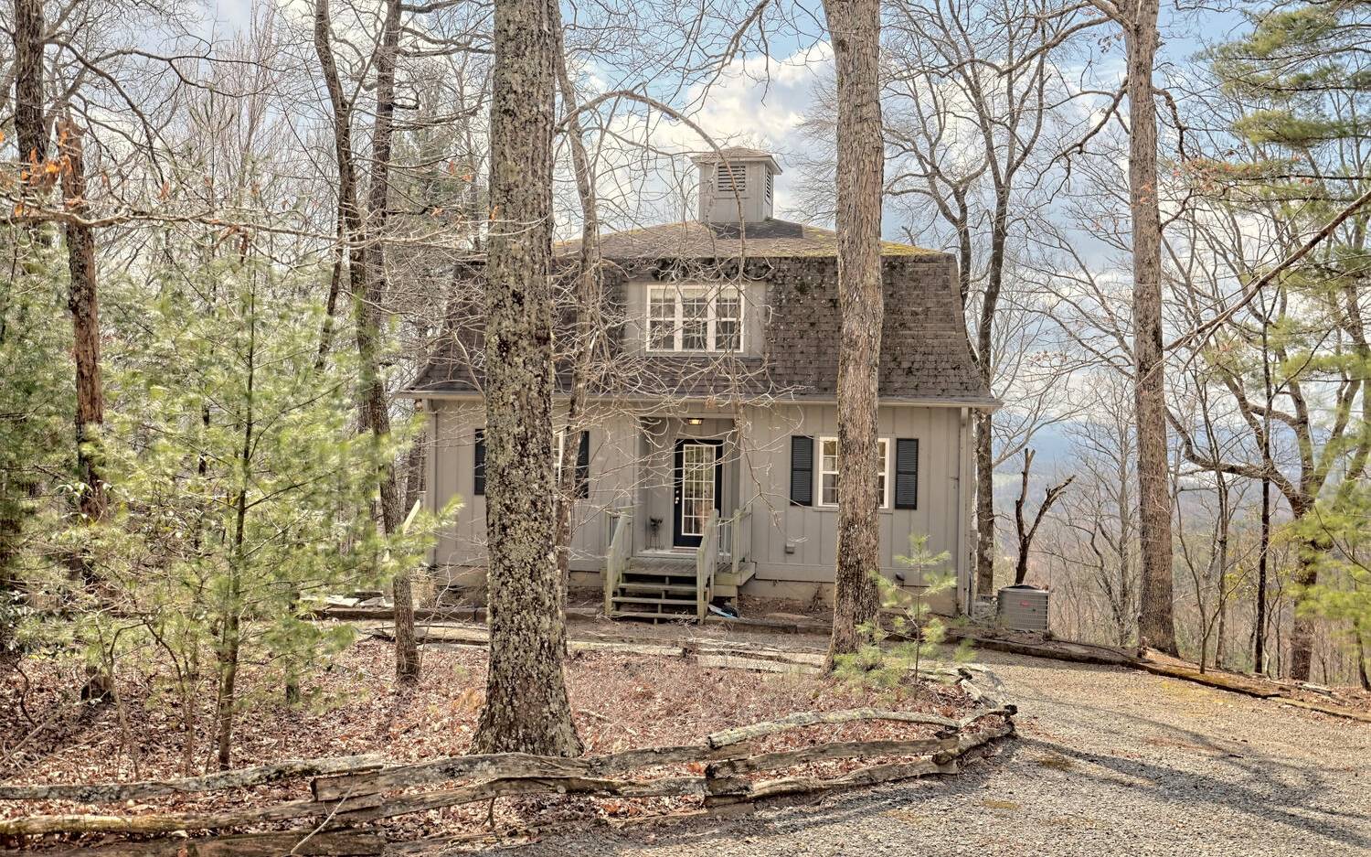 417 Hidden Forest Lane Hayesville, NC 28904 - Photo 3 of 4 a view of a brick house with large windows