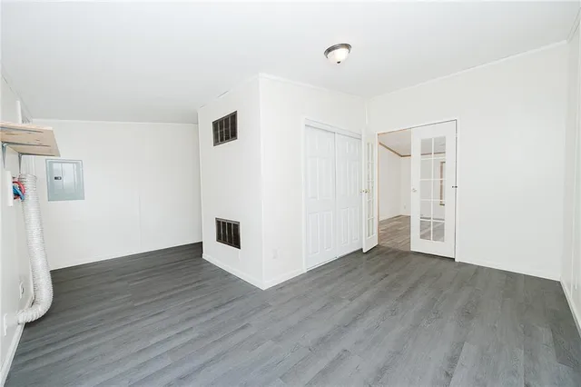 a view of an empty room with wooden floor