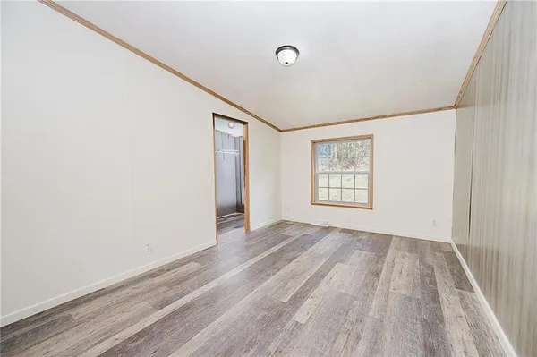 a view of a room with wooden floor