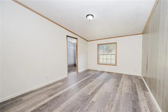 a view of a room with wooden floor