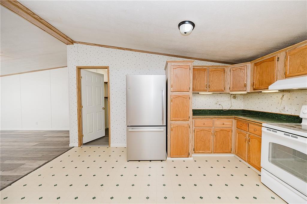 155 Baker Road Worthington, PA 16262 - Photo 31 of 50 a kitchen with granite countertop a refrigerator and a sink