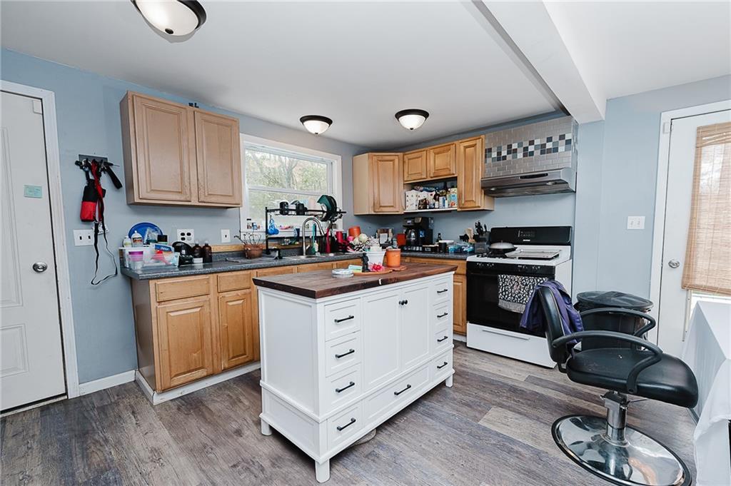 155 Baker Road Worthington, PA 16262 - Photo 36 of 50 a kitchen with granite countertop a sink cabinets and wooden floor