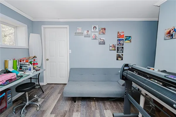 a bedroom with a bed window and a flat screen tv