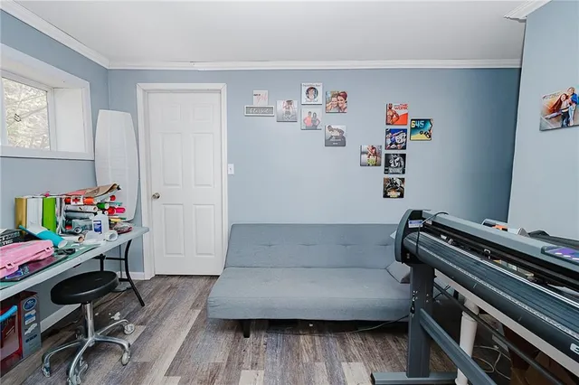 a bedroom with a bed window and a flat screen tv