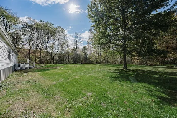 a view of a field with trees