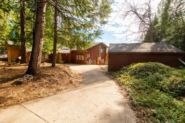 a bedroom with a bed and a dresser next to a window