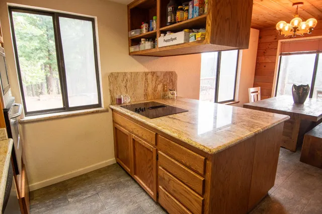 a bathroom with a sink vanity granite tub shower and mirror